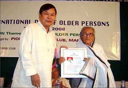 Prof Gangmumei Kamei presenting a gift to a senior citizen on October 01 2008