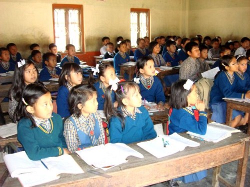 Children of KG grade listening to a class teacher in rapt attention on the first day of class resumption after four months' closure in January 2010 