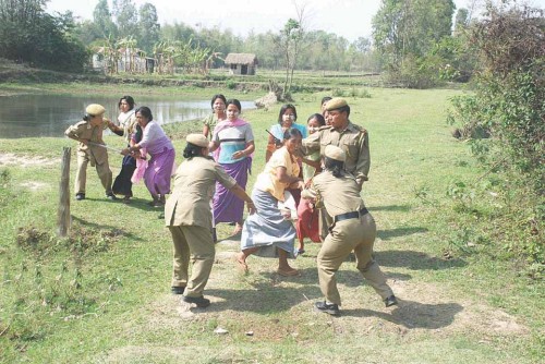 Police engaging in a scuffle with women protesters against government's move to acquire land for expansion of a power sub-station at Yurembam on April 05 2010