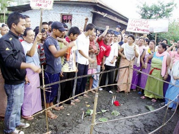 Floral tributes being paid to one of the two dead students at Sangakpham Imphal 