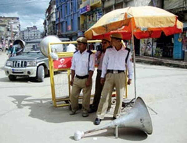 Traffic policemen are seen busy with loud PA system on a scorching summer day at MG Avenue, SSS Hotel junction