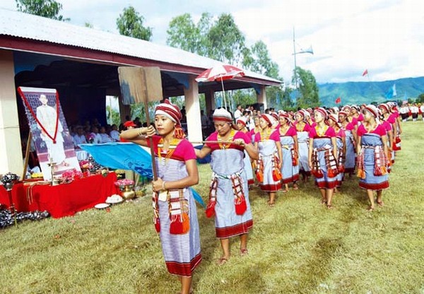 A contigent of students giving salute to the portrait of Hijam Irawat on the occasion of Manipur Kanba Numit at Challou