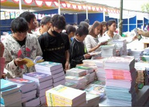 Visitors throng a book stall on its opening day