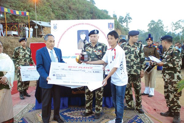 DGP Y Joykumar presenting prize money to the best player of the tournament Ngouba of TLSN, Nambol in the closing ceremony of the CRPF Running Football Tournament