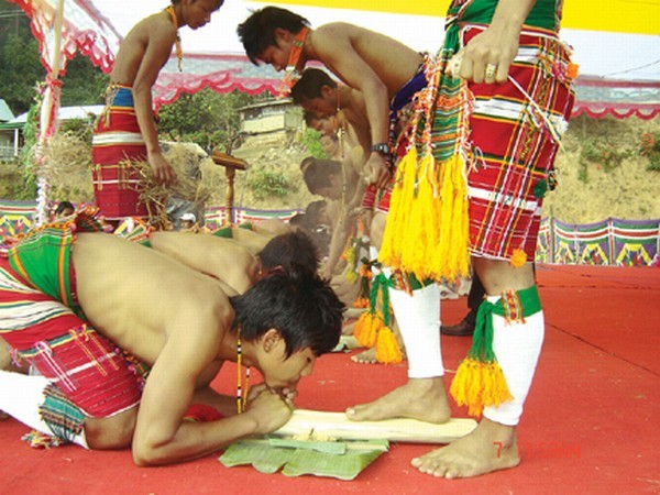 Zeliangrong youths extracting sacred fire (Meiba Chingba) using bamboo splinters at the occasion of Gaangai celebration at Chinikon village ground