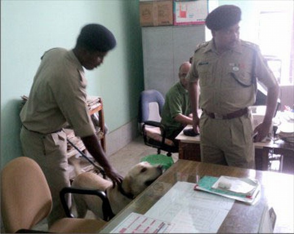 CRPF personnel with sniffer dog sanitising New Secretariat