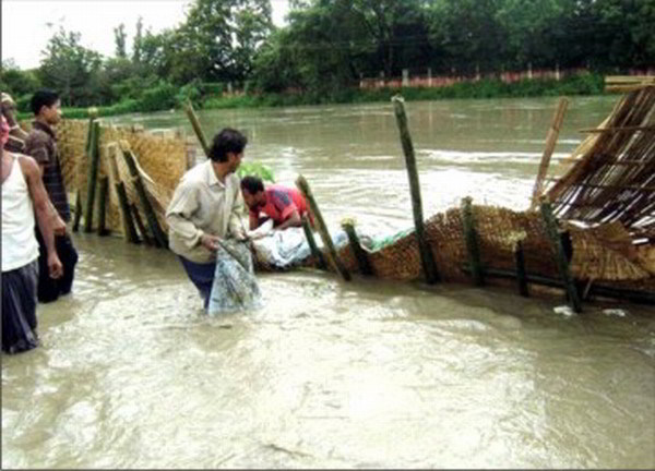File picture of local people trying to mend a breached portion
