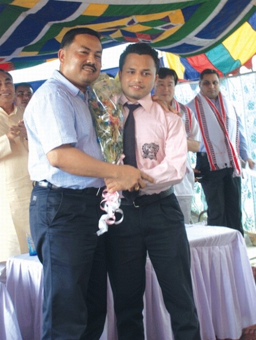 Education Minister M Oken congratulating Md Ismat, who tops the CBSE exam, 2012 on May 29 2012