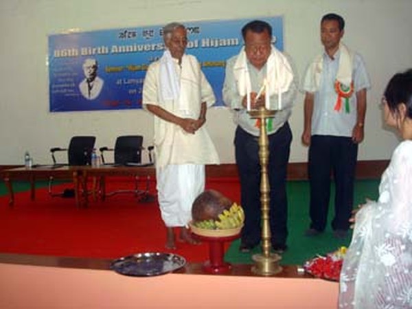 A dignitary lighting a ceremonial at the seminar