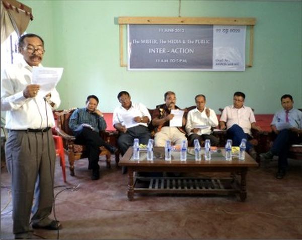 A Lokendrajit delivering a speech and the panellists