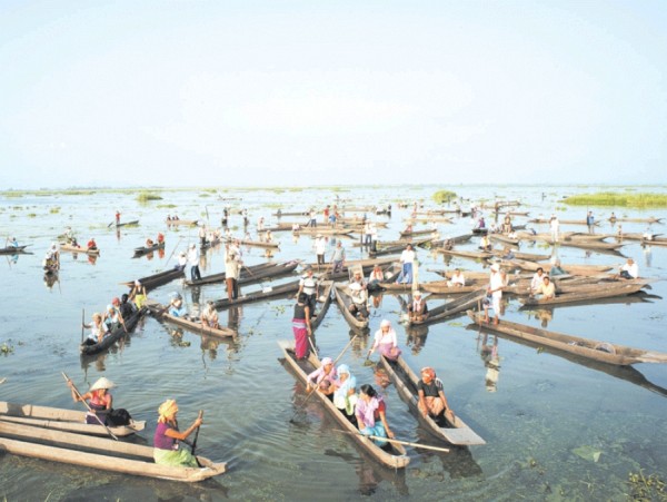 Fishermen in their traditional fishing boats participating in the 'Save Environment Campaign' organised by All Loktak Lake Area Fishermens Union Manipur at Loktak lake in connection with World Environment Day, 2012.