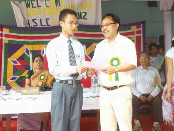 Minister of Works Dr Kh Ratankumar giving away meritorious award to one of the student toppers