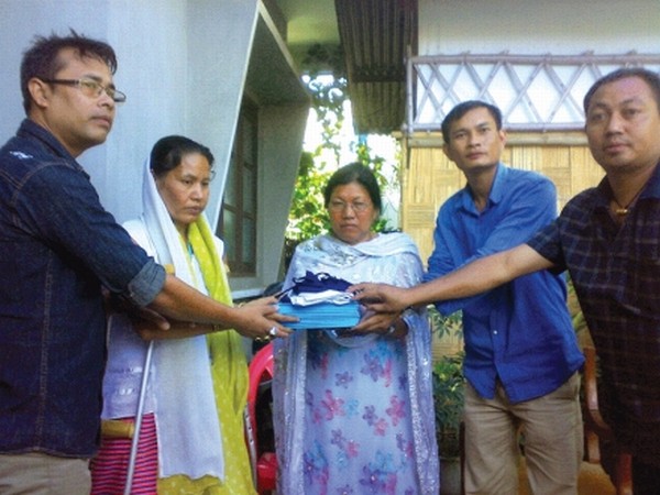Representatives of MSF and Little Rose Hr Sec School handing over text books and uniform to S Sobita for her daughter, Anupama