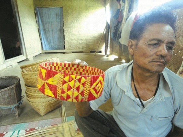 An elderly Maring man showing a cultural artifact