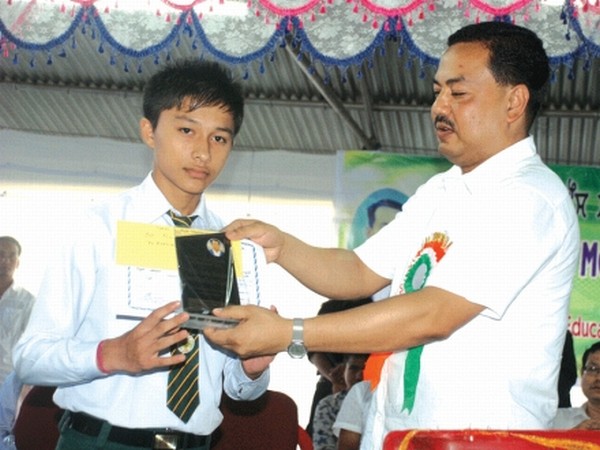 Education Minister M Okendro giving away meritorious award to a student of Heirok A/C