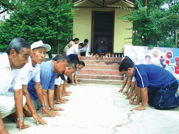 In support of State Olympians: Elderly citizens participating in a mass prayer session