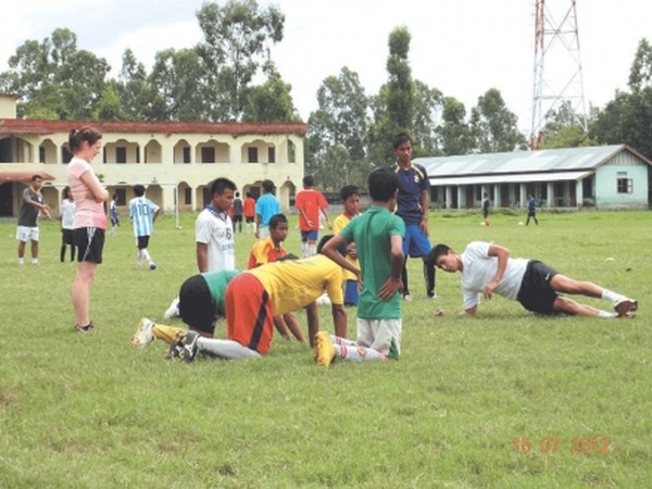 nternatinonal footballer Potshangbam Renedy giving training to budding players of Moirang at Moirang Multipurpose Hr Sec School while Chitrasen (blue) and Teressa from Norway (pink shirt) look on