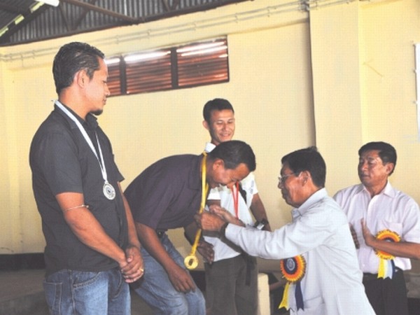 Wangkhem Rishikesh, sports reporter of Hueiyen Lanpao receiving Gold medal after he won the first place in .22 Open Sight Standard Rifle Prone 50M