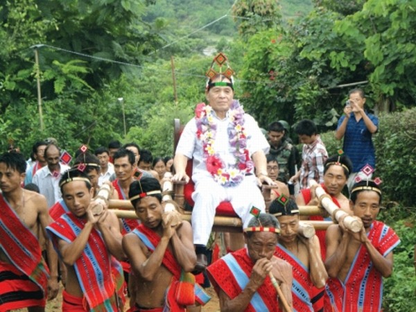 Villagers welcoming MLA Yamthong Haokip in a traditional manner while coming to participate in Mangkhap Phanit festival