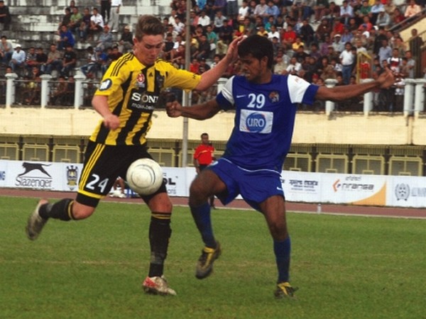 Tyler Boyd of Wellington Phoenix (yellow & black) and Rahul Jaiswal of United Sikkim (blue) vying for the ball during the first match of the North East Lajong Super Series at Khuman Lampak Main Stadium, Imphal