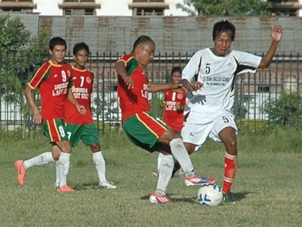 Players of TRAU and TRUGPU vying for the ball during a match of 7th Manipur State League organised by AMFA at Mapal Kangjeibung, Imphal