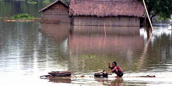 A woman stays adrift on a make shift raft in Assam