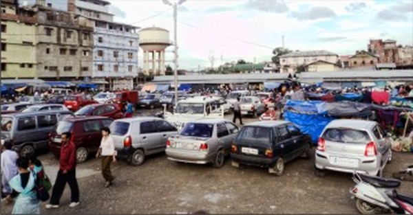Vehicles parked at the parking lot near the temporary market sheds
