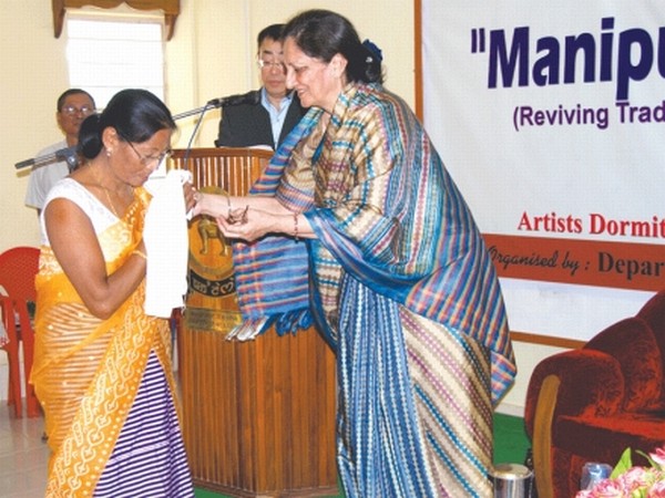 First Lady of the State Kiran Jagat (R) making a presentation to one of the participants on the concluding day of the workshop on reviving traditional appliqu art of Manipur