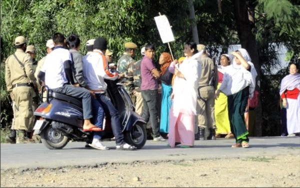 Local womenfolk block the Imphal-Ukhrul road to denounce the bomb blast