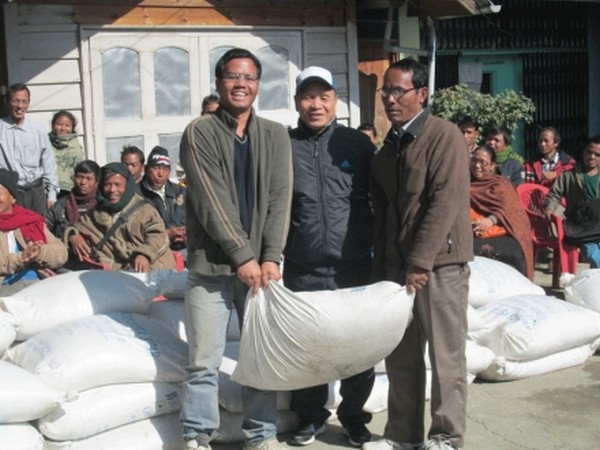 MLA of Saikul A/C Yamthong Haokip presenting Christmas gifts in the form of sugar bags to villagers of his home constituency